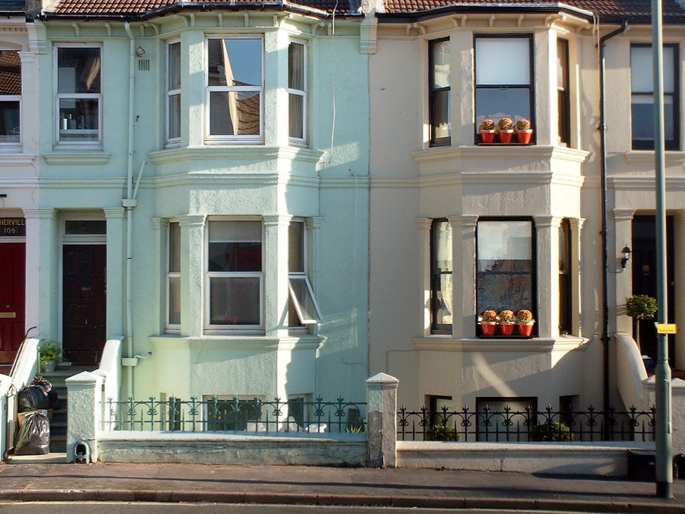 Painted bay fronted terraced houses in evening light in Brighton